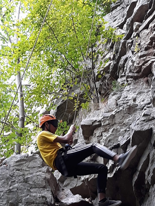 Former LIFE student rock climbing